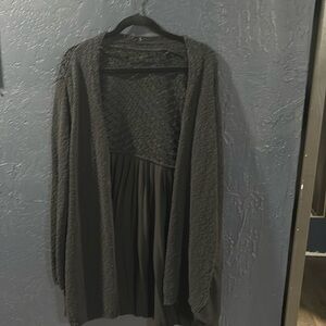 Black sweater cardigan with lace like back and sheer on the bottom of back.